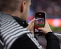 A social media content creator films using their mobile phone during a match this season.