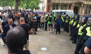 Police in riot gear block an exit from Parliament Square.