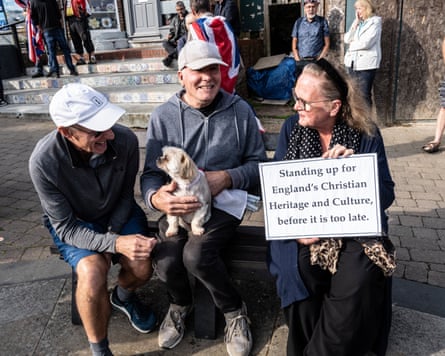 Three people and a dog – the women holds a sign saying ‘standing up for England’s Christian heritage and culture, before it is too late’