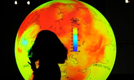 A scientist standing in front of a globe delivers a speech at Cop in Copenhagen, 15 December 2009.