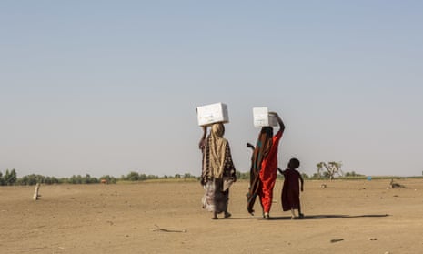 Pastoralist women displaced by drought carry food rations from a distribution point to the Farburo site for internally-displaced people in Gode, in the Somali region of Ethiopia.