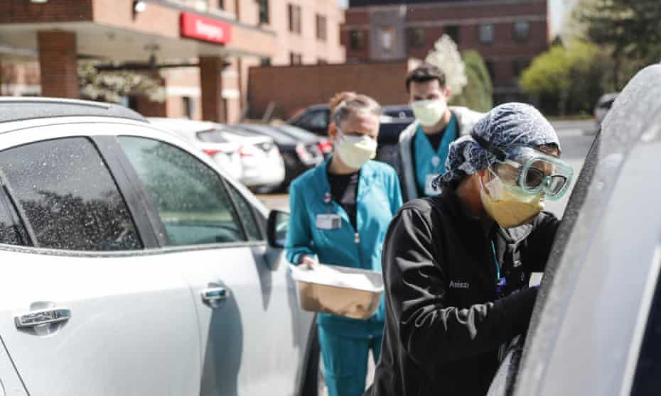 Hospital workers test patients for Covid-19 outside of the emergency entrance of Beaumont hospital in Grosse Pointe, Michigan. 