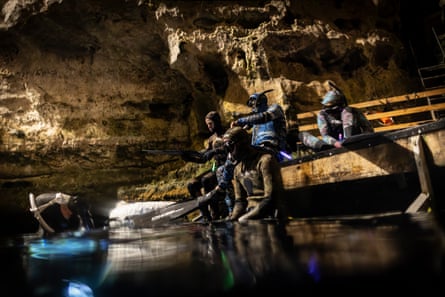 Free divers prepare their gear in a cave