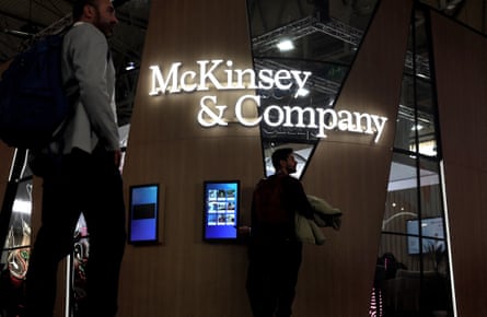 people walking by a McKinsey sign