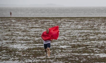 man walks as coat blows in the wind