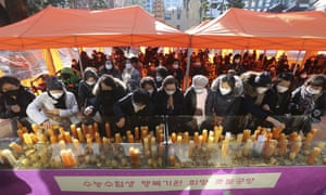 Parents place candles during a special service to wish for their children’s success in the college entrance exams at the Jogyesa Buddhist temple in Seoul, South Korea, Thursday, 3 December 2020.