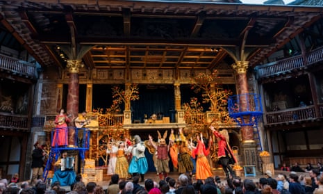 A scene from Much Ado About Nothing by William Shakespeare on stage at the Globe theatre, with Mediterranean orange trees climbing the back wall of the set
