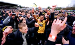 Maidstone United's Liam Sole celebrates on the pitch with fans at the end of their win over Stevenage.