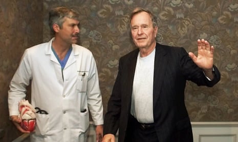 Former president George HW Bush waves as he leaves Methodist hospital with his cardiologist, Mark Hausknecht. Joseph James Pappas, the man suspected of killing the Hausknecht, shot himself during a confrontation with police Friday.