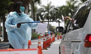 A healthcare worker at a Covid-19 testing site outside of Marlins Park in Miami. Florida reported a record rise in deaths this week.