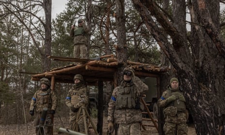 Members of Ukraine’s territorial defence forces watch as their comrades take part in a military training exercise near Chernobyl, Ukraine