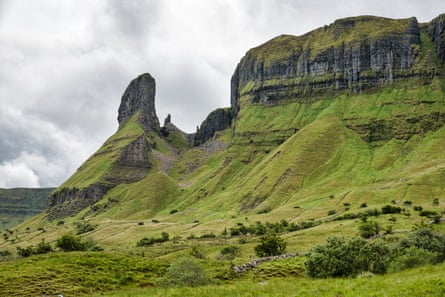 Rocky pinnacle and mountain covered in grass