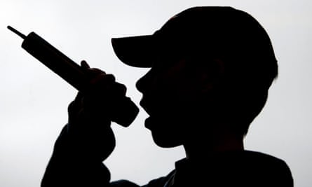 Silhouette of a young boy wearing a baseball cap rapping or singing into a microphoneBA320C Silhouette of a young boy wearing a baseball cap rapping or singing into a microphone