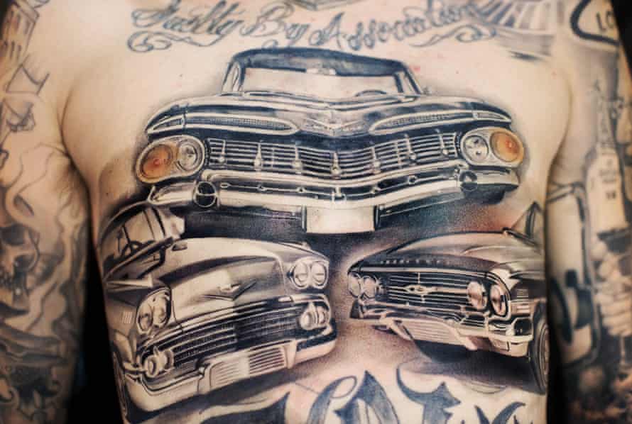 chest with lowrider tattoos