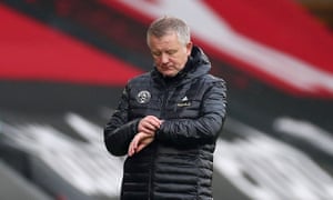 Chris Wilder checks his watch.
