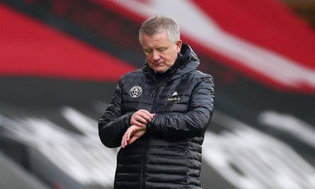 Chris Wilder checks his watch.