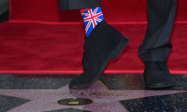 Hugh Laurie shows off his socks while standing on his just unveiled Star during his Hollywood Walk of Fame star ceremony.