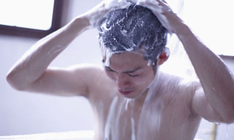 Man washing hair in shower.