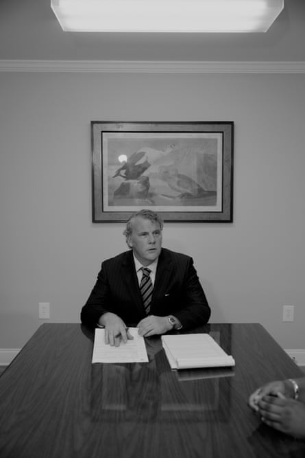 A middle-aged man in a suit in an office.