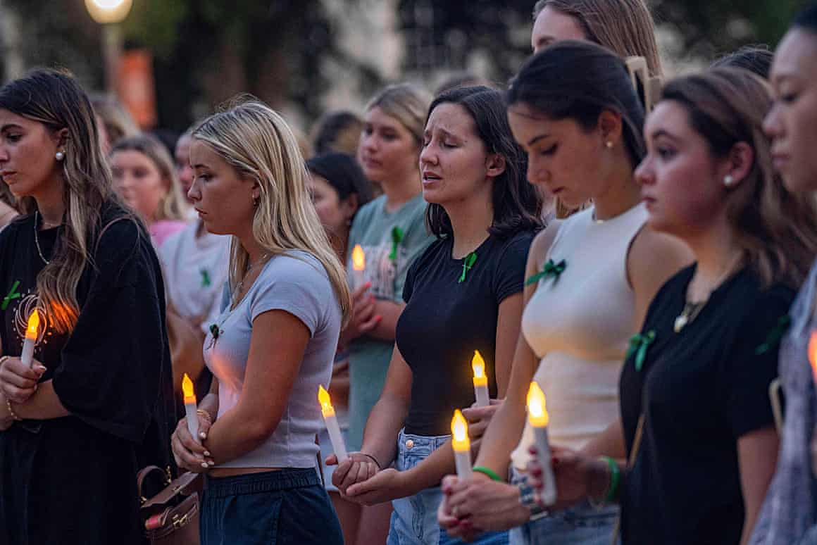 Young people hold candles during a vigil