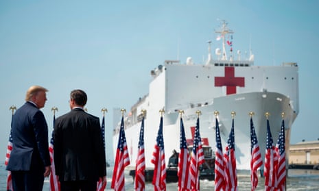 Defense Secretary Mark Esper and President Donald Trump watch as the hospital ship USNS Comfort leaves Naval Base Norfolk, in Virginia, for New York.