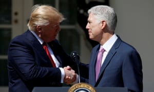 Donald Trump shakes hands with Judge Neil Gorsuch after he was sworn in as a supreme court justice.