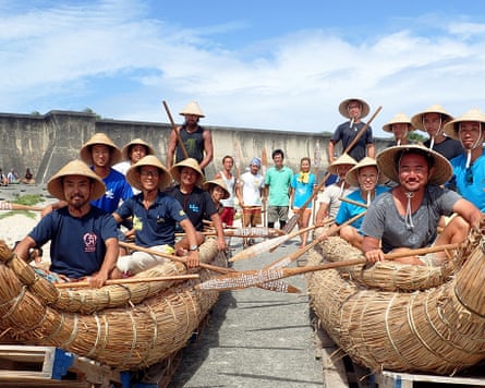 Paddlers sit in reed-bundle rafts. The team experimented with different materials before settling on Japanese cedar.