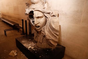 A vandalised statue of the Marianne, a symbol in France, inside the Arc de Triomphe