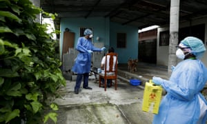 A health ministry worker takes a sample from a resident as his team goes from home to home to administer fast Covid-19 tests in the Nuevo Tocumen neighborhood of Panama City, Monday, 15 June 2020.