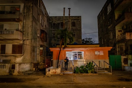 A small bakery in the streets of Havana, Cuba, at night, lit by a battery lantern as the city now has many power cuts