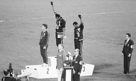 Tommie Smith and John Carlos (center and right) make their stand on the podium in 1968 alongside Peter Norman