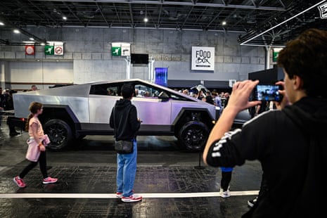 people look at and take pictures of a car with no curved edges