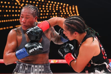 Lani Daniels (right) lands a correct manus connected Shadasia Green during their unified super-middleweight title fight.