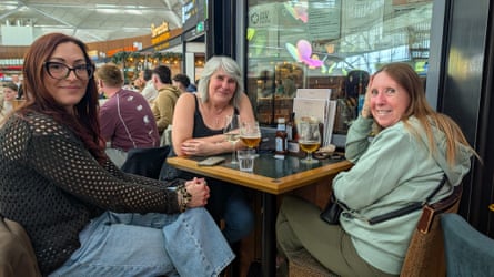 Three women having drinks at a table