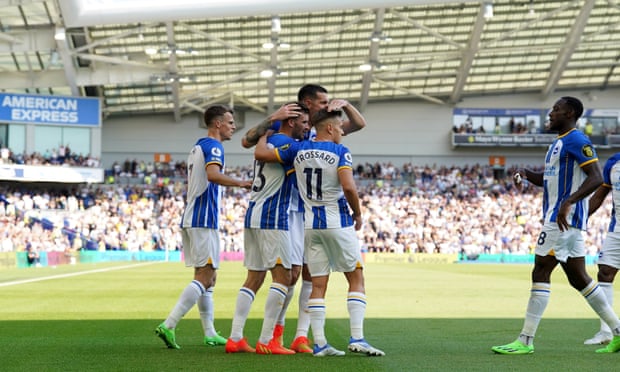 Brighton players embrace after the only goal in their game against Leeds at the Amex