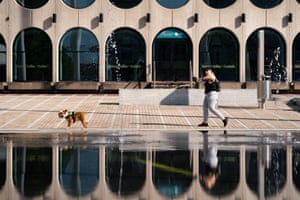 A woman walks her bulldog in Centenary Square, Birmingham