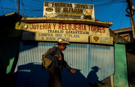 A man walks past a gold and jewellery shop in Santa Rosa de Lima, El Salvador