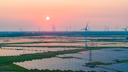 Wind turbines above photovoltaic panels operate at the tidal flat industry demonstration base in Yancheng City, Jiangsu Province.