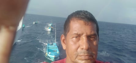 a man’s face with boats at sea in the background