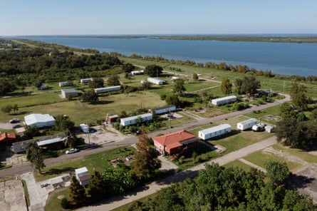 A suburban community sitting on the banks of a large river.