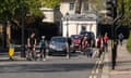 Cyclists on a road in front of cars