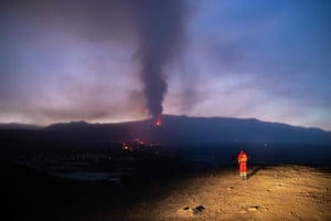 A member of the Spanish military emergency unit monitors the lava flow