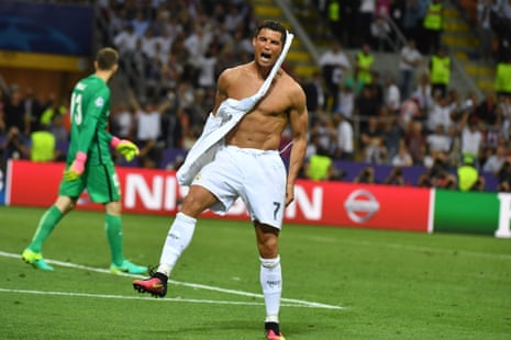Ronaldo rips his shirt off after scoring the winning penalty.