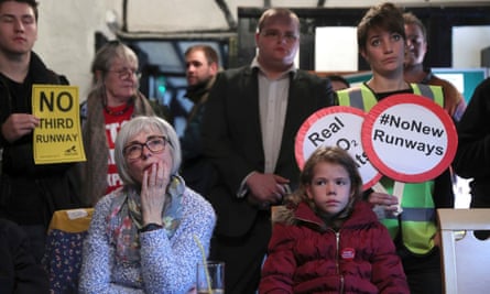 Residents of Harmondsworth village watch television in the Five Bells pub as Transport Secretary Chris Grayling announces the government’s decision to build a new runway at Heathrow Airport.
