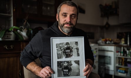 Elezović holds two photographs of himself