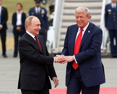 President Donald Trump holds the hand of Russian President Putin in Alaska in August 2025 on the latter's visit to America.