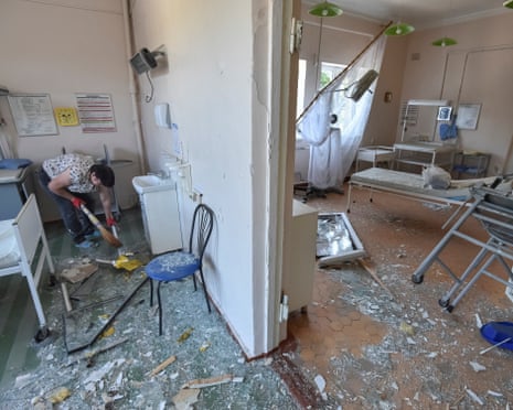 A woman cleans the damaged ward in a hospital which was hit by a Russian missile strike, amid Russia's attack on Ukraine, in the city of Kamianske, Dnipro region.