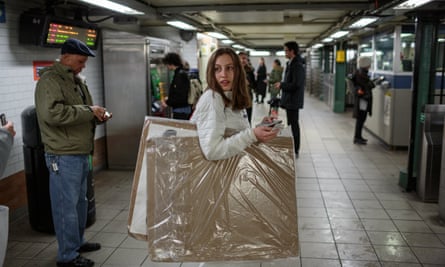 Alexandria commutes on the subway to the UN, holding her protest signs.