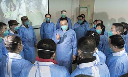 Chinese Premier Li Keqiang, center, speaks with medical workers at a hospital in Wuhan.