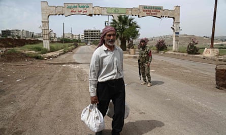 A Syrian man walks away from the entrance to Afrin.